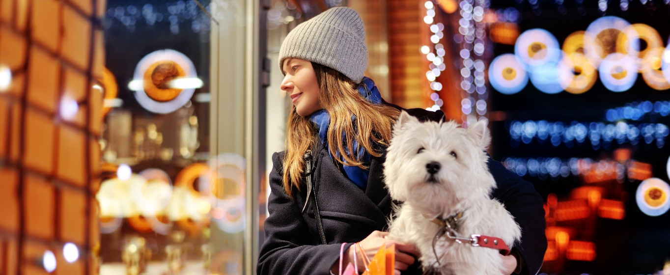 a young woman window shopping during the holidays